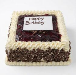 Egg-free Black Forest birthday cake with soft chocolate sponge, fresh dairy topping, chocolate curls around the sides, rich cherry glaze topping, personalised edible message plaque, and elegant piped border. Ideal for birthdays, anniversaries, and special occasions.