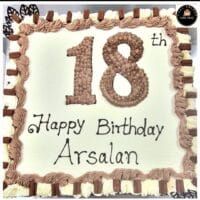 18th birthday egg-free fresh cream cake with chocolate piping, chocolate finger bars, decorative chocolate leaves, and personalised message