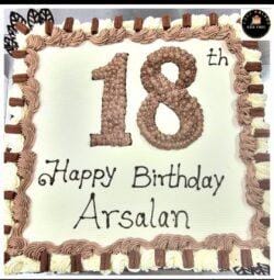 18th birthday egg-free fresh cream cake with chocolate piping, chocolate finger bars, decorative chocolate leaves, and personalised message