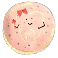 Round pink tooth-themed birthday cake with adorable tooth character and personalized message