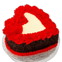 Egg Free red heart-shaped celebration cake with red rose decorations and chocolate flakes around the sides