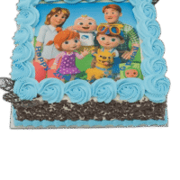 Egg Free Family Cartoon Photo Cake with an edible character image, blue cream swirls, chocolate curl sides and decorative chocolate leaves.