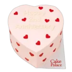 Pink heart anniversary cake with red heart decorations and custom message