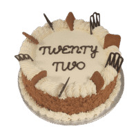 Egg Free Biscoff Celebration Cake decorated with Lotus Biscoff biscuits, Biscoff crumb coating, decorative chocolate pieces and a personalised message.