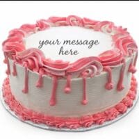 Round white fresh cream birthday cake with pink drip decoration, pink piped borders, textured sides, and a personalised message.