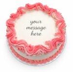 Top view of a white fresh cream cake featuring a pink drip border and space for a personalised birthday message.