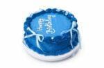 Round blue fresh cream birthday cake with white ribbon bows, shell borders, pearl decorations, and a custom birthday message.