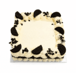 Top view of a square Oreo celebration cake decorated with smooth white whipped frosting, Oreo biscuit halves, crunchy Oreo cookie crumb pieces around the border, and a large smooth centre for a personalised birthday or celebration message.
