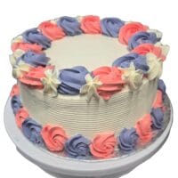 Round fresh cream cake decorated with pink and lavender fresh cream rosettes, white floral accents, textured white sides, and space for a personalised message.