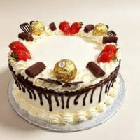 Chocolate drip celebration cake with fresh cream icing, chocolate ganache drip, fresh strawberries, Ferrero Rocher chocolates, chocolate curls, chocolate sticks and chocolate decorations, round birthday cake with space for personalised message, Cake Palace UK.
