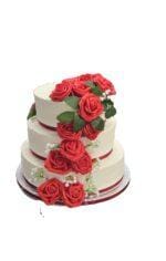 Egg Free three tier wedding cake with cascading red roses, white floral accents and elegant cream finish.