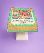 Egg Free Cocomelon Photo Birthday Cake with an edible Cocomelon image, green cream borders, rainbow sprinkle sides and a personalised message.