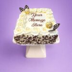Egg Free Ferrero Chocolate Celebration Cake decorated with Ferrero chocolates, chocolate leaves, mixed chocolate curls and a personalised message.