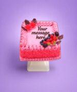 Egg Free Pink Berry Celebration Cake decorated with fresh strawberries, blueberries, raspberries, blackberries and chocolate decorations