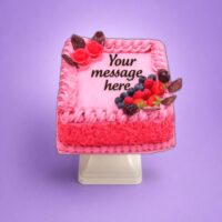 Egg Free Pink Berry Celebration Cake decorated with fresh strawberries, blueberries, raspberries, blackberries and chocolate decorations