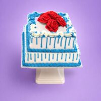 Royal Blue Drip Rose Celebration Cake with fresh cream finish and red roses by Cake Palace