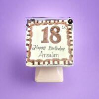 18th birthday egg-free fresh cream cake with chocolate piping, chocolate finger bars, decorative chocolate leaves, and personalised message