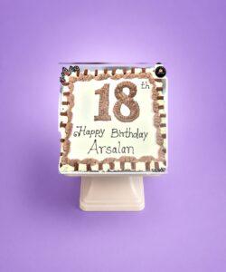18th birthday egg-free fresh cream cake with chocolate piping, chocolate finger bars, decorative chocolate leaves, and personalised message