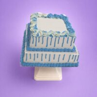 Egg Free Blue Drip Tier Celebration Cake with two square tiers, blue drip decoration and elegant blue cream swirls.