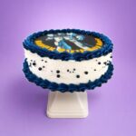 Blue Robot Photo Birthday Cake with edible robot image, navy blue fresh cream piping, white fresh cream finish, and decorative sugar pearls.
