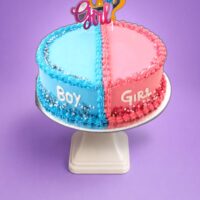 Boy or Girl gender reveal heart cake with blue and pink frosting and topper