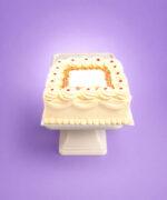 Square fresh cream celebration cake with smooth piped cream icing, rainbow sprinkles border, classic jam dots, decorative cream swirls, and space for a personalised birthday or celebration message, handmade by Cake Palace UK.