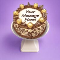 Treat your guests to our handcrafted Egg Free Ferrero Celebration Cake, beautifully decorated with Ferrero chocolates, chocolate wafer pieces, chocolate swirls and chocolate flakes around the sides. Perfect for birthdays and special occasions, this elegant cake can be personalised with your own message. Freshly made to order in Sheffield and available in Chocolate, Mix Fruit Jam, Biscoff, Mango or Pistachio flavours.