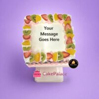 Egg-free fresh fruit fresh cream cake topped with strawberries, kiwi, pineapple, and personalised message