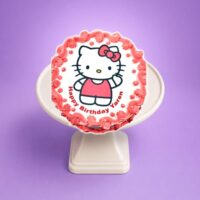 Hello Kitty photo birthday cake with edible image, pink fresh cream rosettes, floral decorations, and personalised message