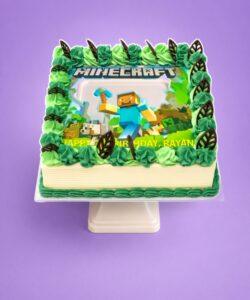 Minecraft photo birthday cake with edible image, green fresh cream rosettes and chocolate leaf decorations
