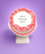 Top view of a white fresh cream cake featuring a pink drip border and space for a personalised birthday message.