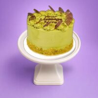 Premium pistachio celebration cake with chocolate decorations in Sheffield