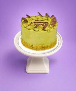 Premium pistachio celebration cake with chocolate decorations in Sheffield
