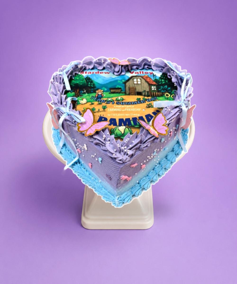 Stardew Valley Heart Celebration Cake Heart-shaped Stardew Valley celebration cake with pastel lavender fresh cream, edible game image, butterflies, ribbon bows and pearl decorations by Cake Palace.