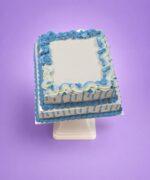 Two Tier Egg Free Blue Birthday Cake featuring a smooth cream finish, blue drip effect and custom message area.